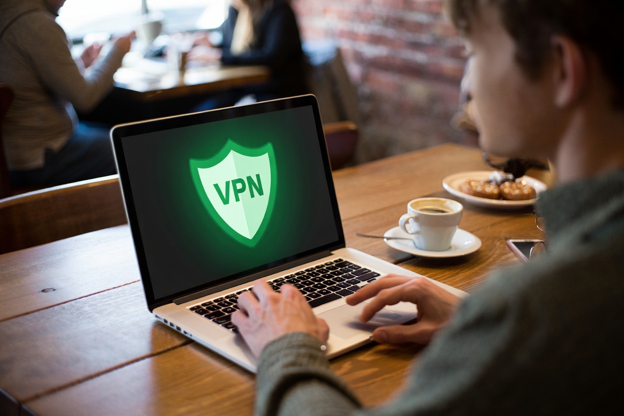 What Is a VPN? A Complete Beginner’s Guide to Online Security 1 User connected to VPN while using public Wi-Fi at a café